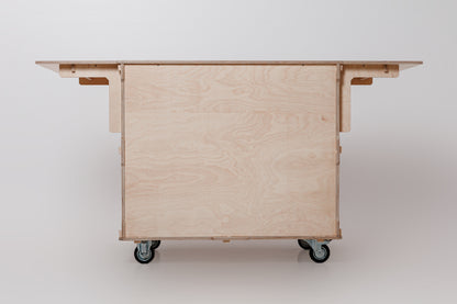 Front view of a mobile coffee cart showcasing a foldable worktop, large storage space, and sturdy design for versatile coffee service
